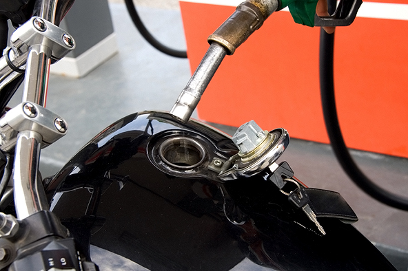 Motorcyclist-fueling-his-motorcycle-at-a-gas-station